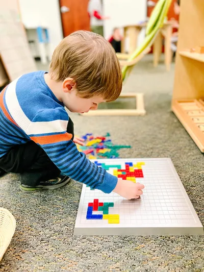 Young boy arranging colorful blocks in Spark Studio